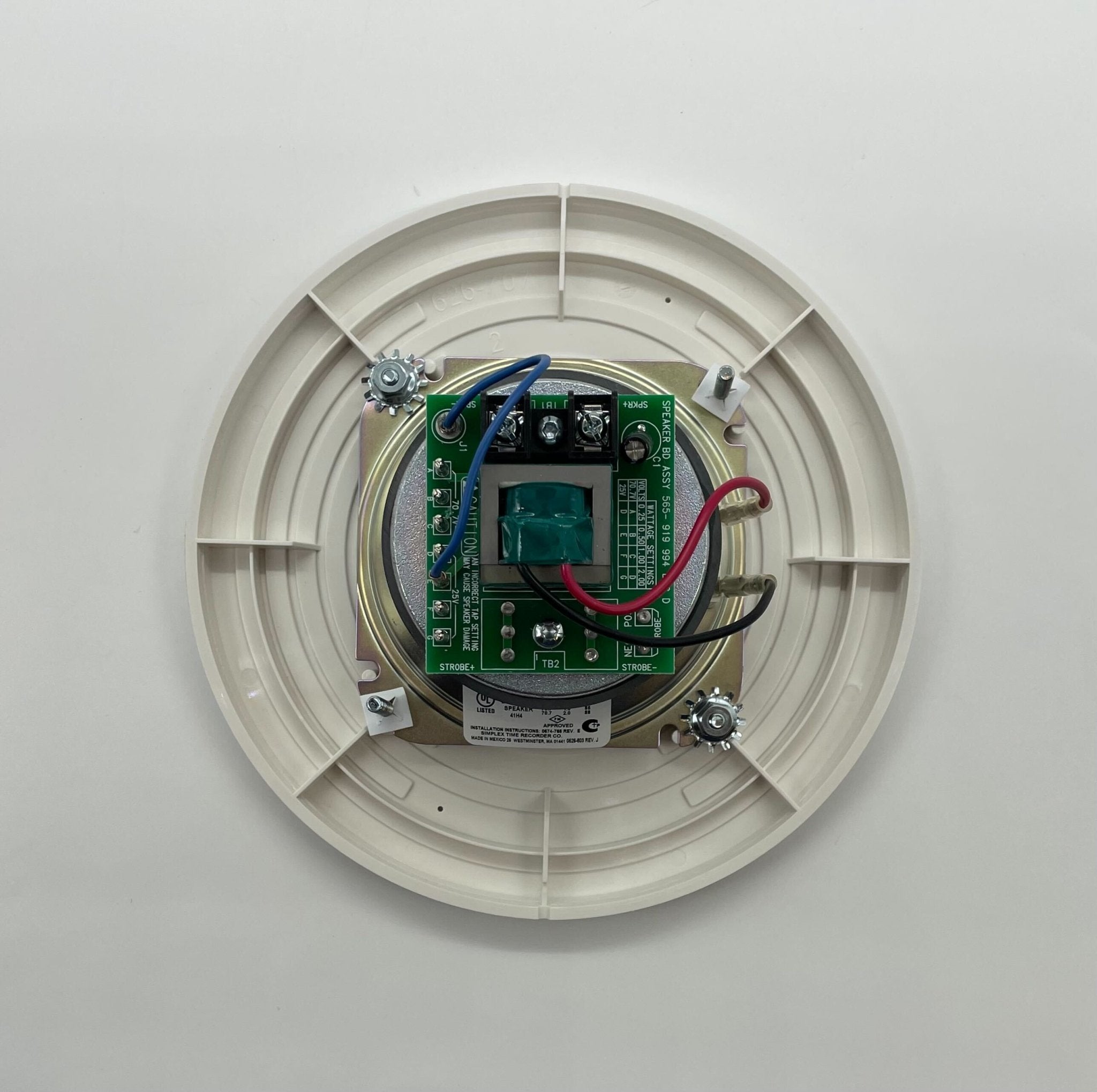 Simplex 4902-9721 fire alarm with white plastic casing, mounted on wall, part of Simplex fire alarm system.