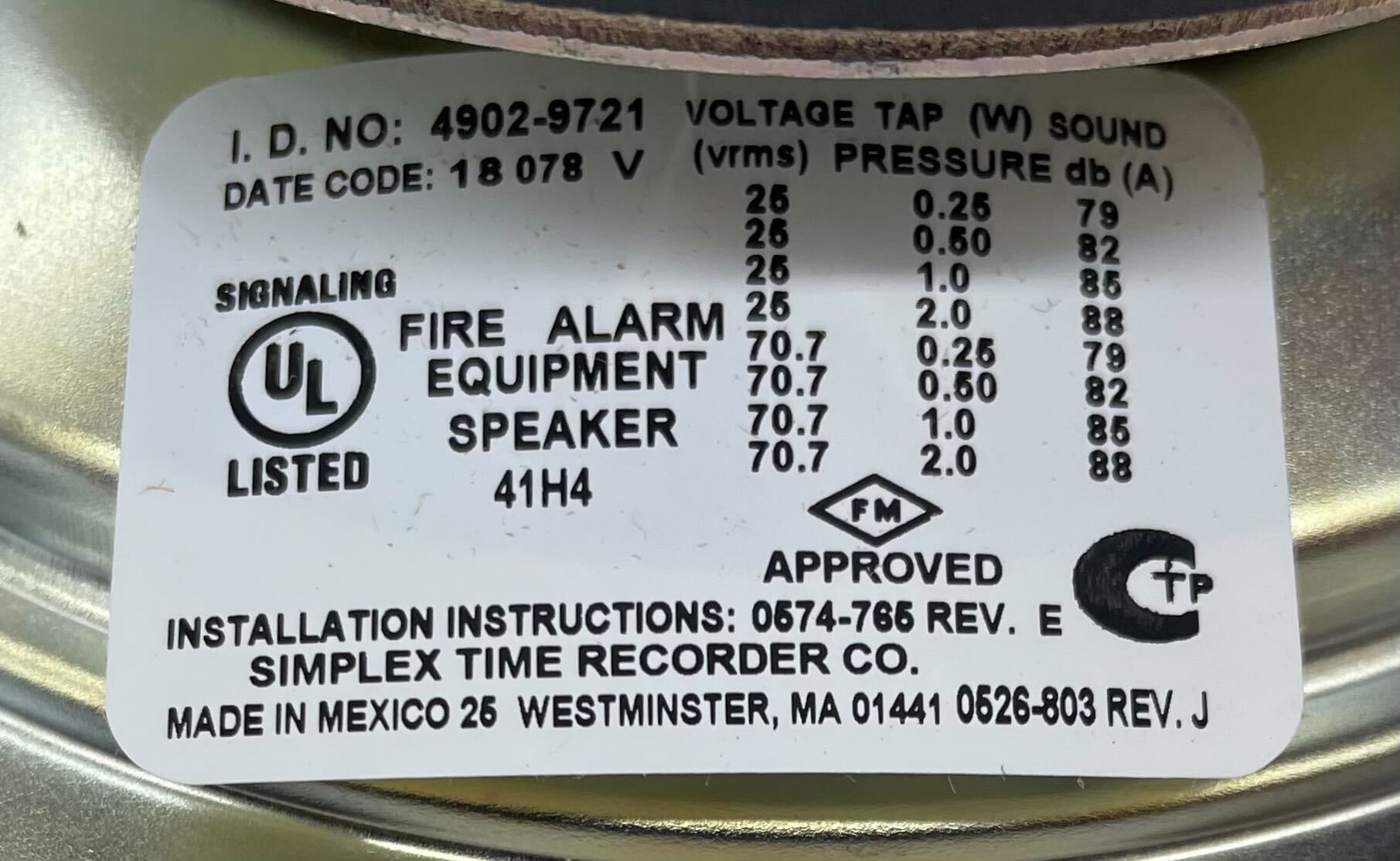 Simplex 4902-9721 fire alarm device with white plastic housing and mounting bracket, designed for building safety.