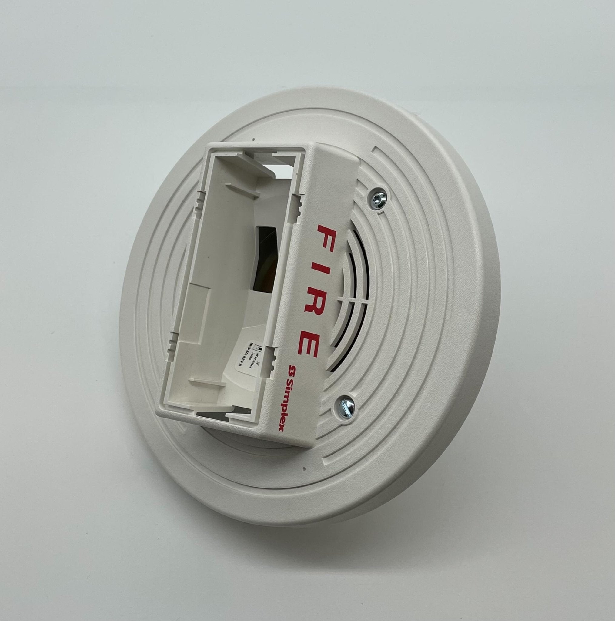 Simplex 4903-9198 fire alarm device with alarm indicator light, mounted on a white wall.