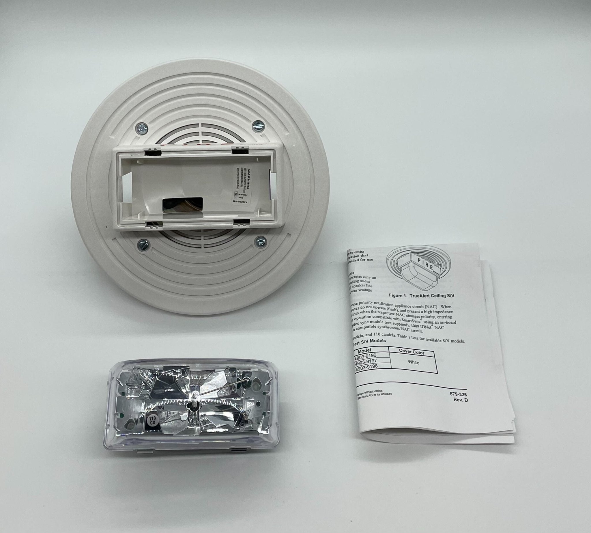 Simplex 4903-9198 fire alarm device, black alarm with test and reset buttons, mounted on a wall.