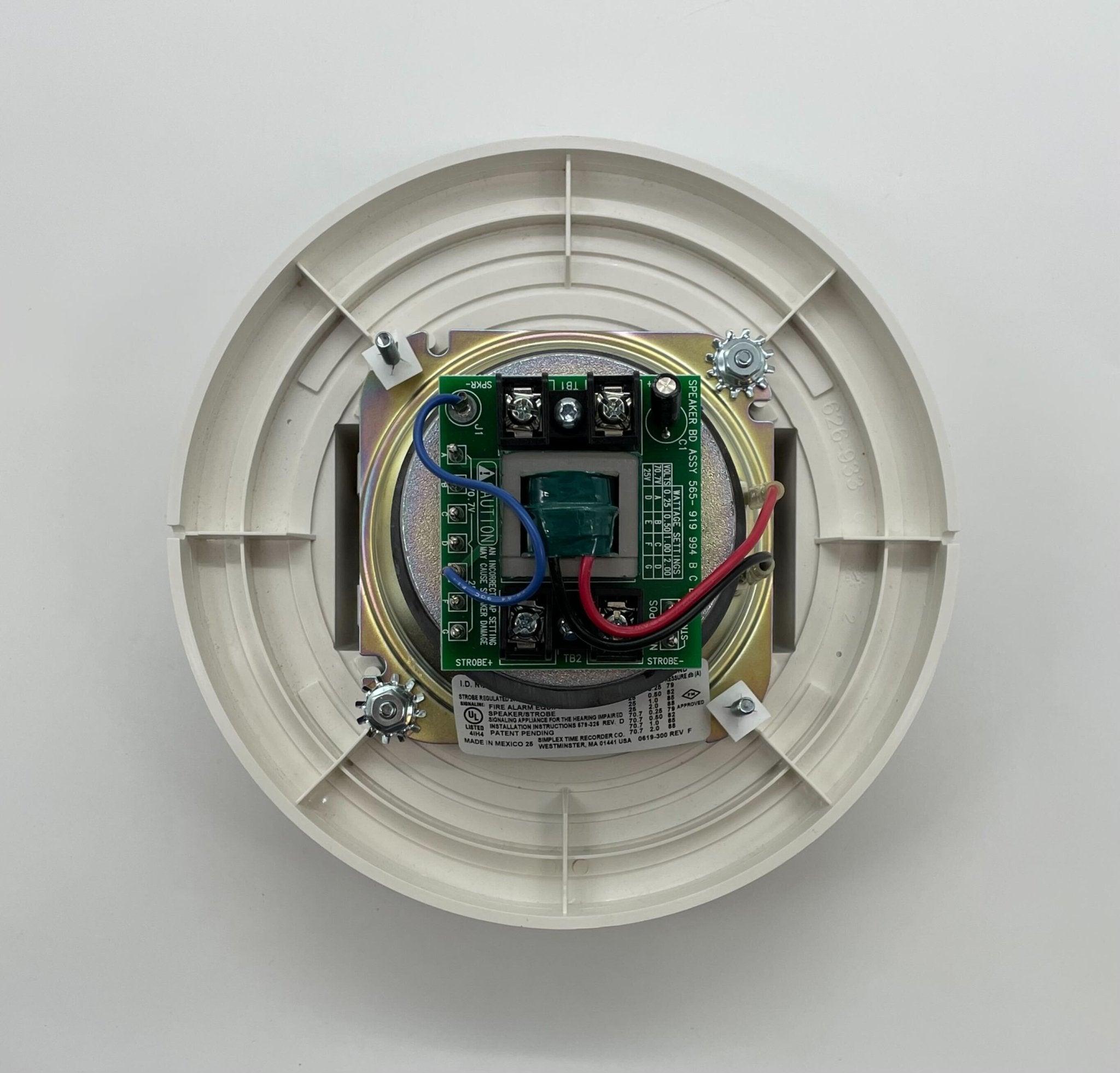 Simplex 4903-9198 fire alarm device, black with test and reset buttons, mounted on a wall.