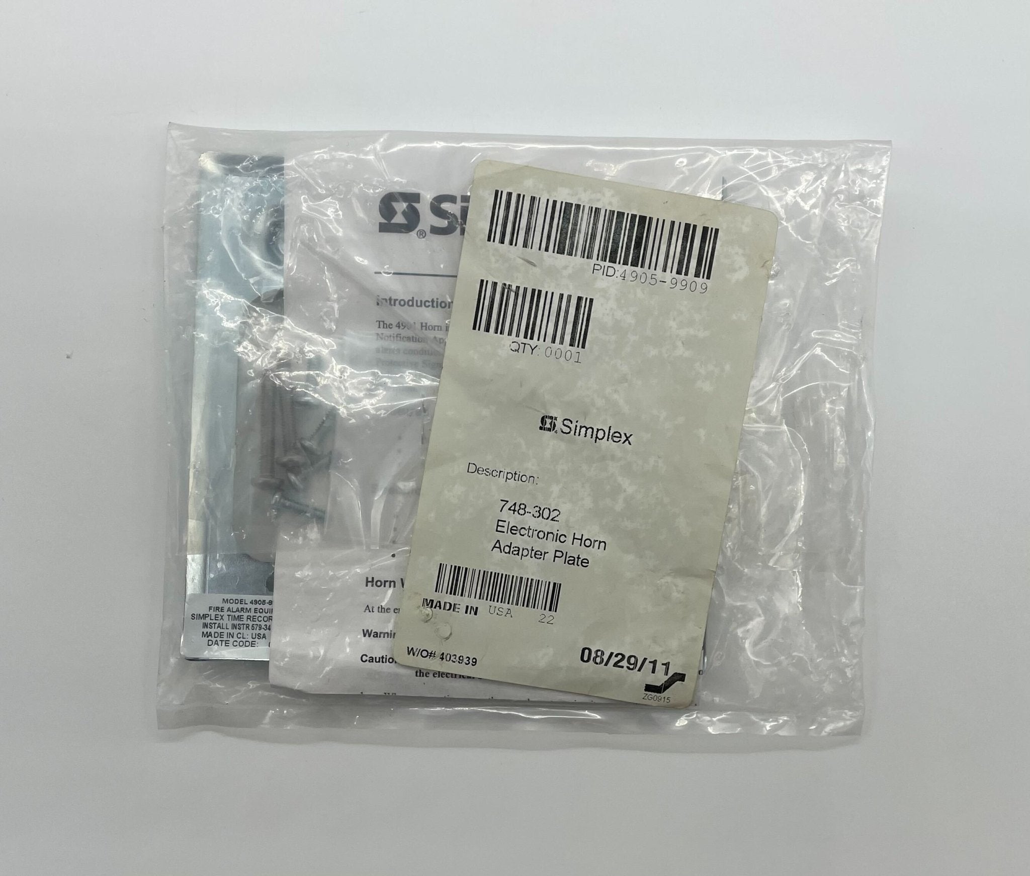 Simplex 4905-9909 fire alarm sensor with white casing, mounted on wall, part of Simplex fire detection systems.