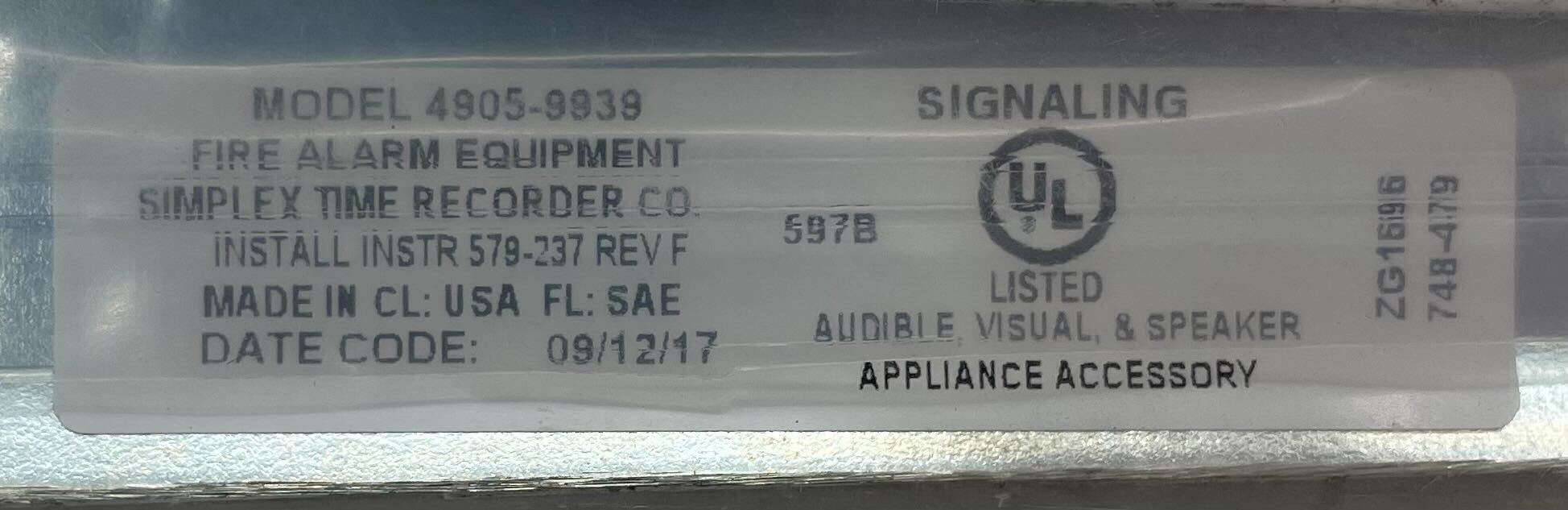 Simplex 4905-9939 fire alarm with smoke detector and warning light, mounted on wall in a building safety system.