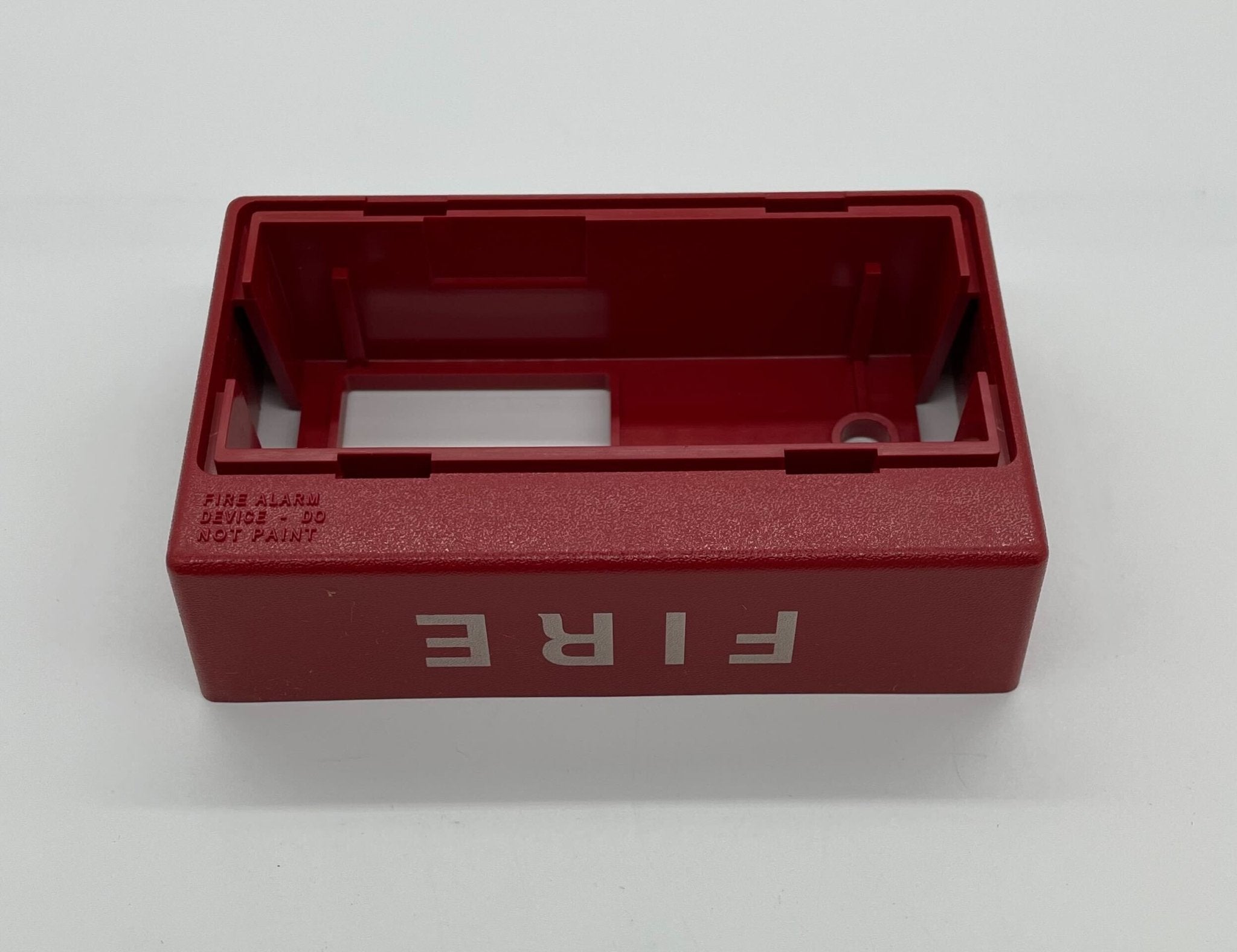 Simplex 4906-9110 fire alarm mounted on wall, featuring a white rectangular detector with a test button and LED indicator.
