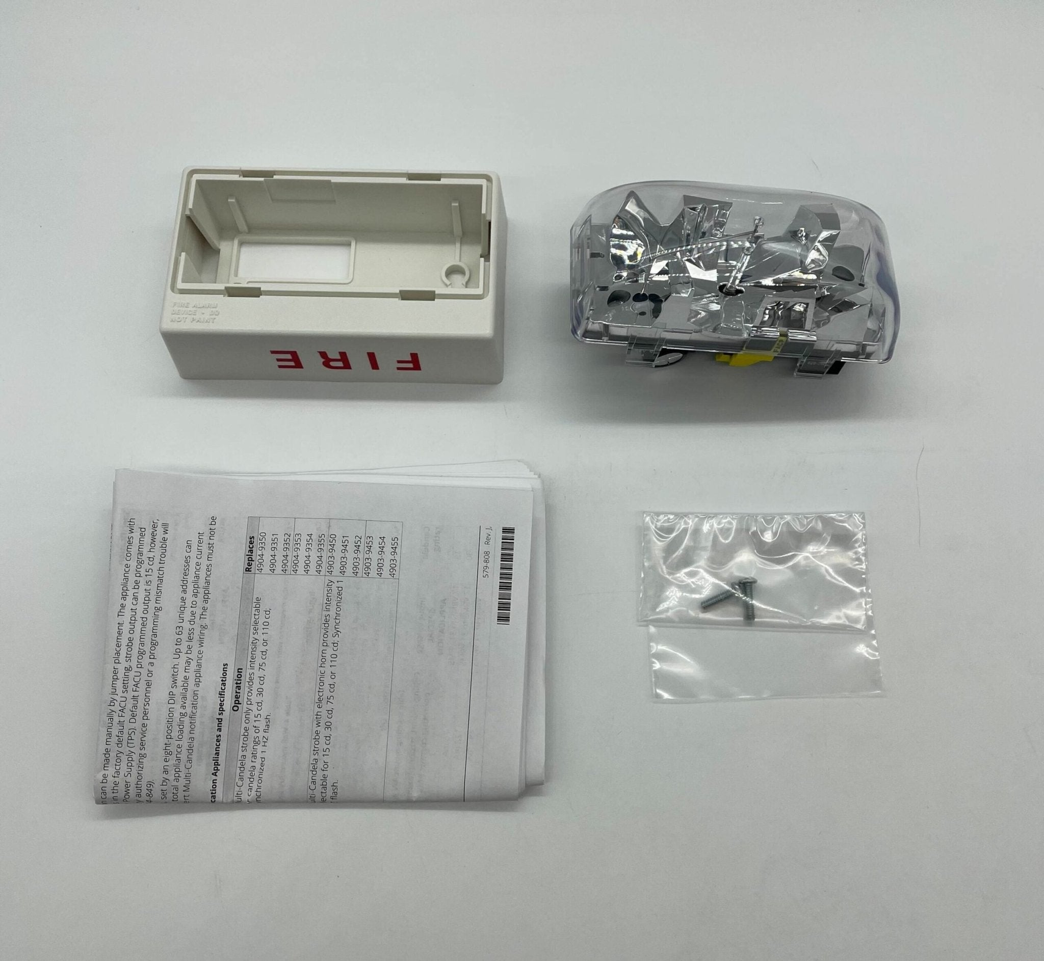 Simplex 4906-9204 strobe light with a clear protective cover, mounted on a metal fixture for emergency or signaling use.