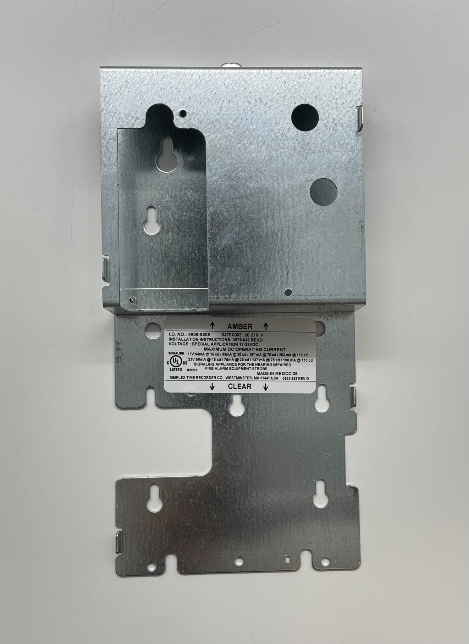 Simplex 4906-9208 fire alarm with a white rectangular design and mounting bracket, used for fire detection and alert systems.