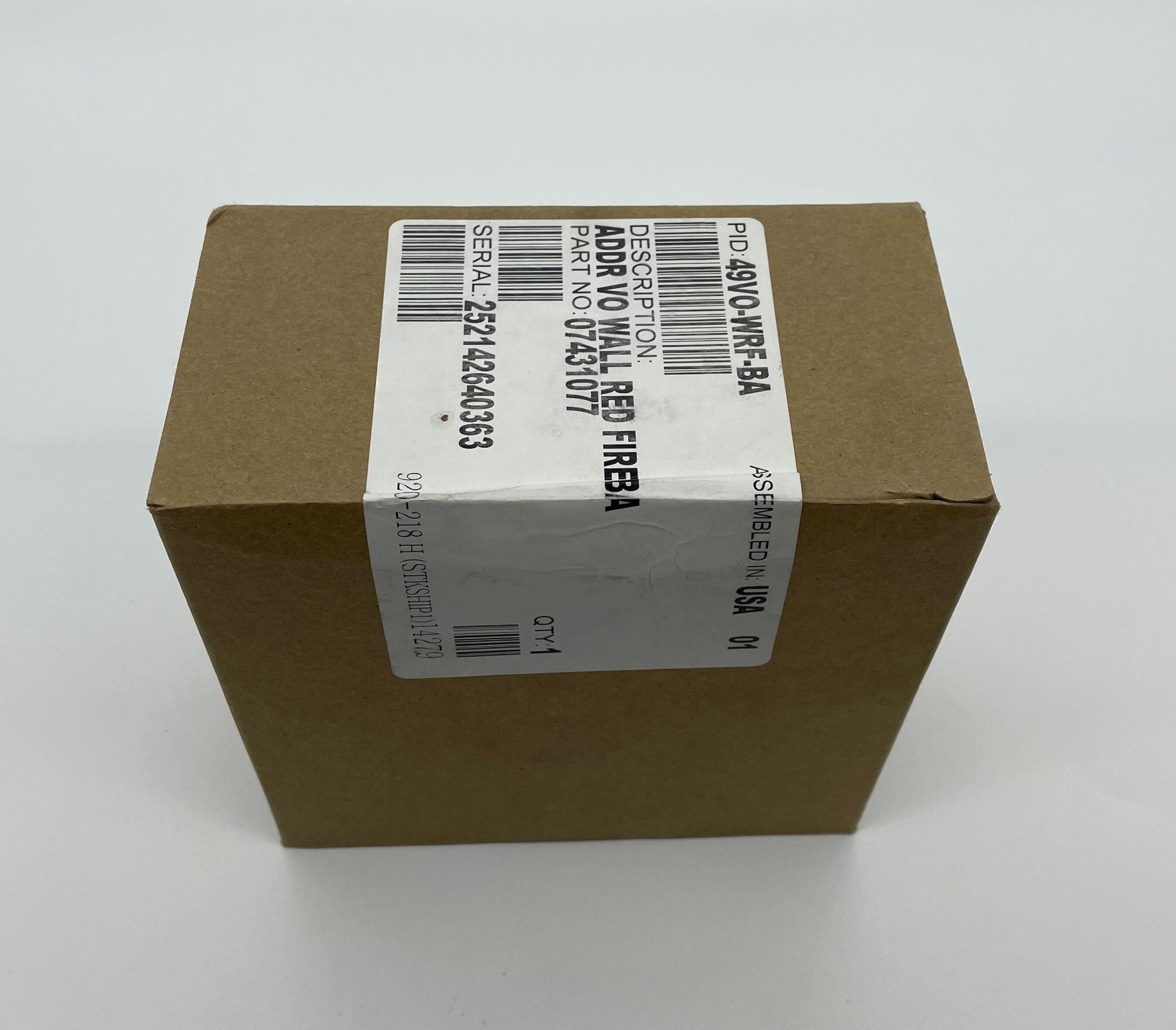 Simplex 49VO-WRF-BA strobe light with white flash, mounted on a ceiling in a commercial setting, designed for emergency signaling.