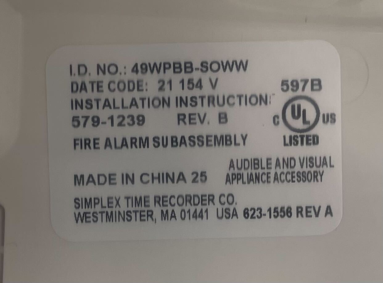 Simplex 49WPBB-SOWW fire alarm with black and white components, designed for building safety and fire detection.