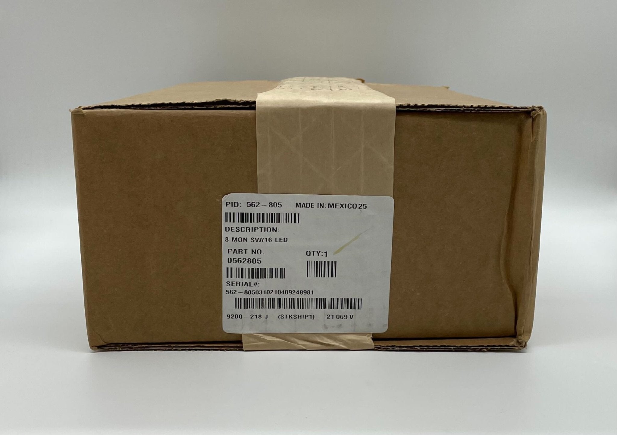 Simplex 562-805 fire alarm device with a white plastic cover and mounting bracket, designed for fire safety systems.