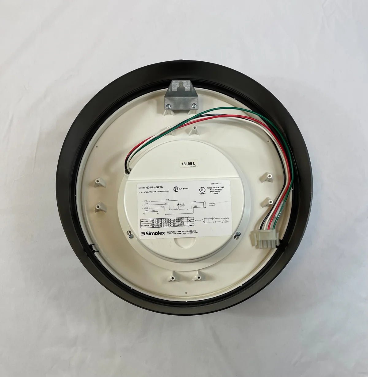 Simplex 6310-9226 fire alarm with digital display and sensor, mounted on a ceiling in a building.