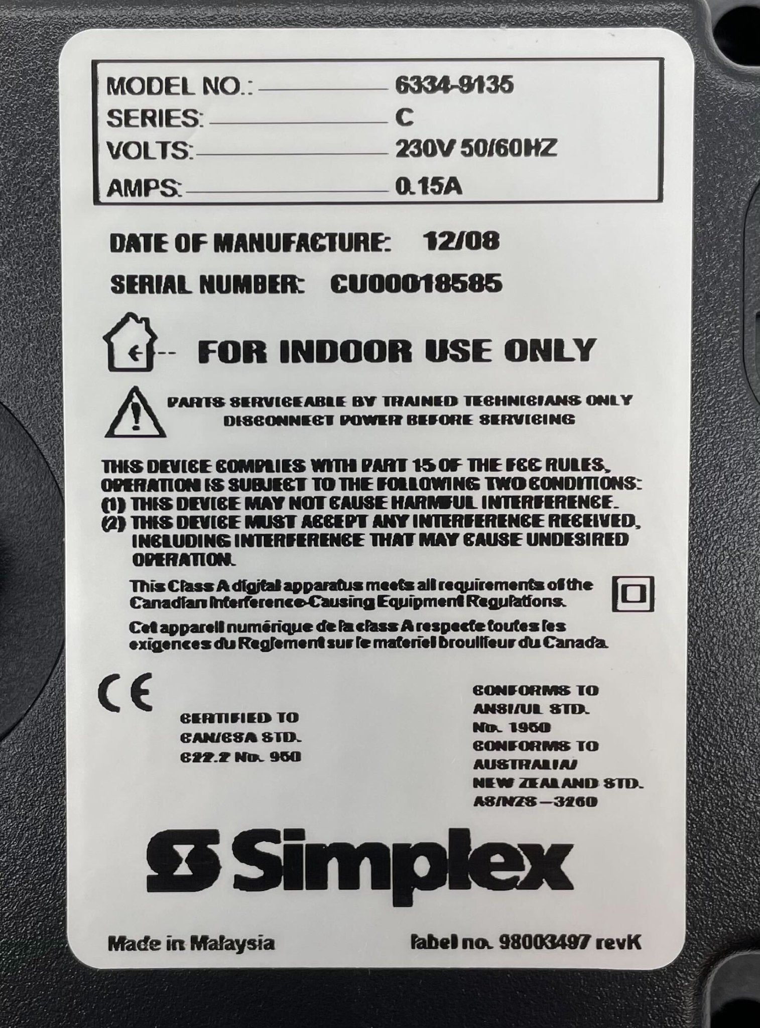 Simplex 6334-9135 fire alarm with white casing and mounting bracket, designed for building safety and fire detection.