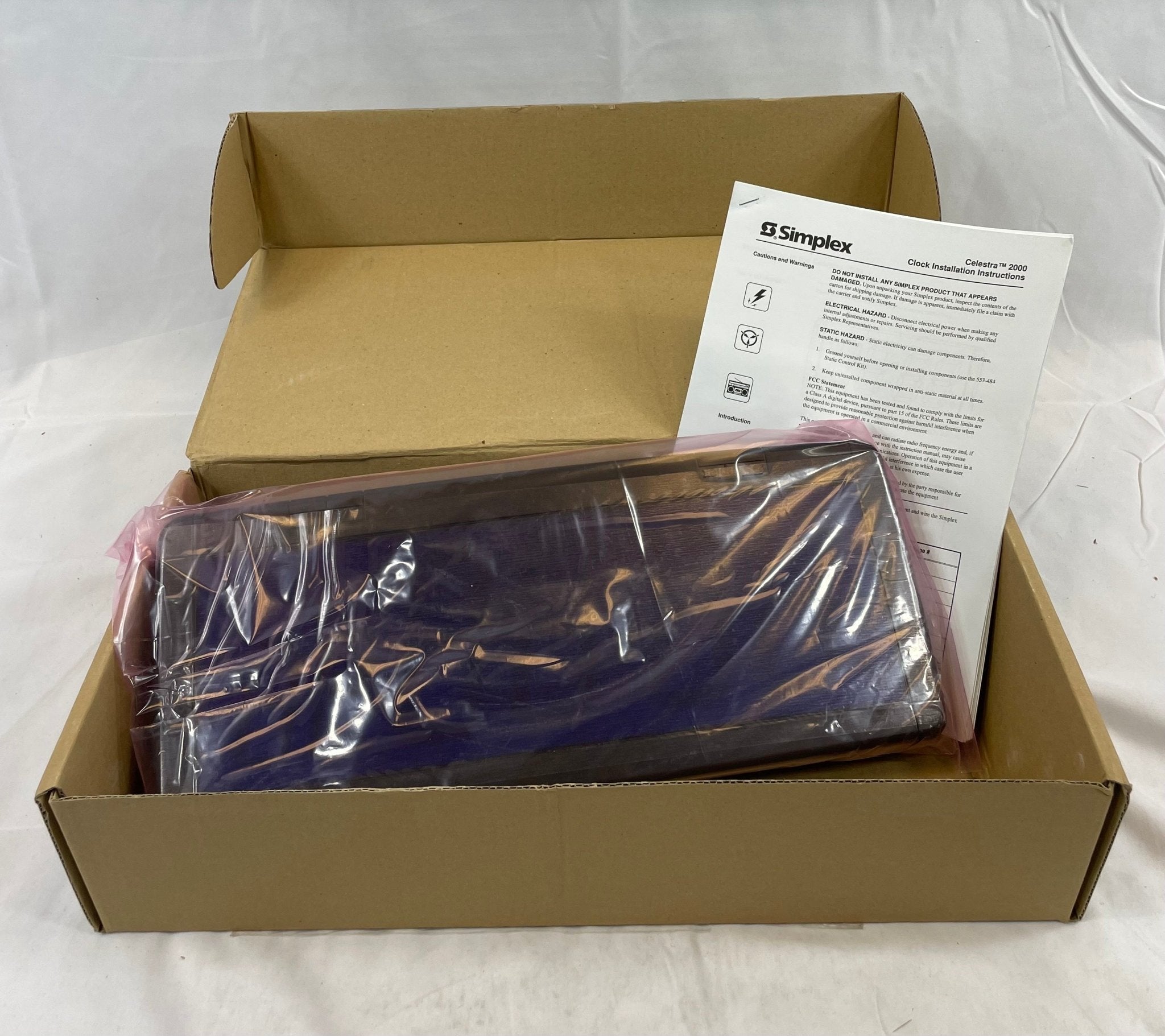Simplex 6334-9144 fire alarm device, black with mounting bracket, designed for fire safety and emergency alert systems.