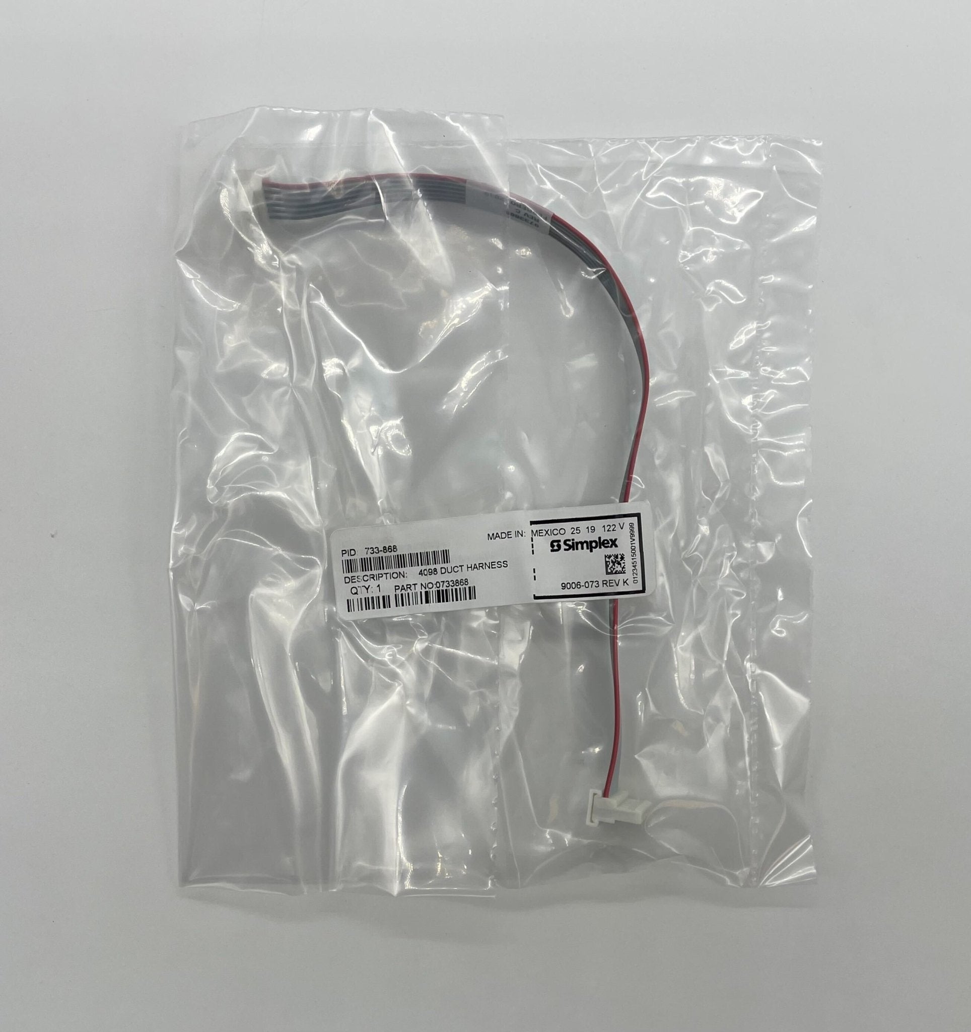 Simplex 733-868 fire alarm device, black, mounted on ceiling, part of Simplex fire alarm system for safety and detection.