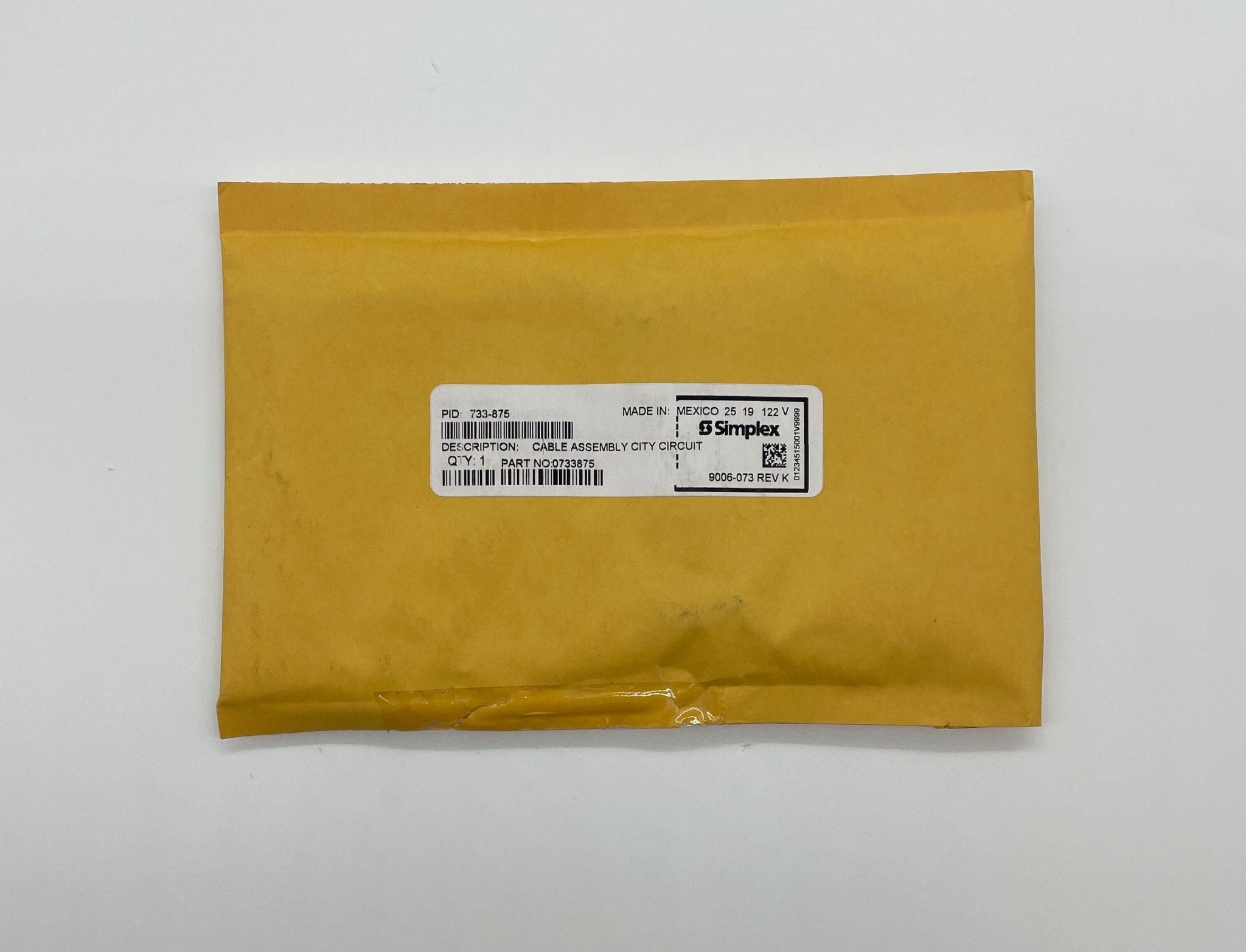 Simplex 733-875 fire alarm with white casing and electronic components, designed for building safety systems.