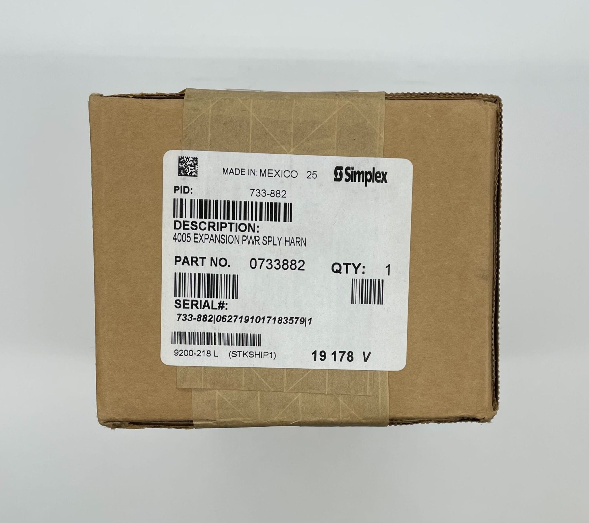 Simplex 733-882 fire alarm device with white casing and mounting bracket, designed for fire detection and safety.