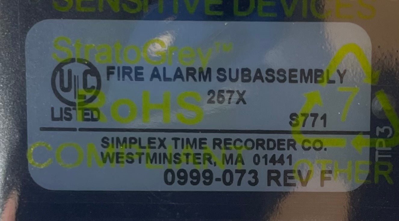 Simplex 742-101 fire alarm with white plastic cover and mounting base, designed for building fire safety systems.