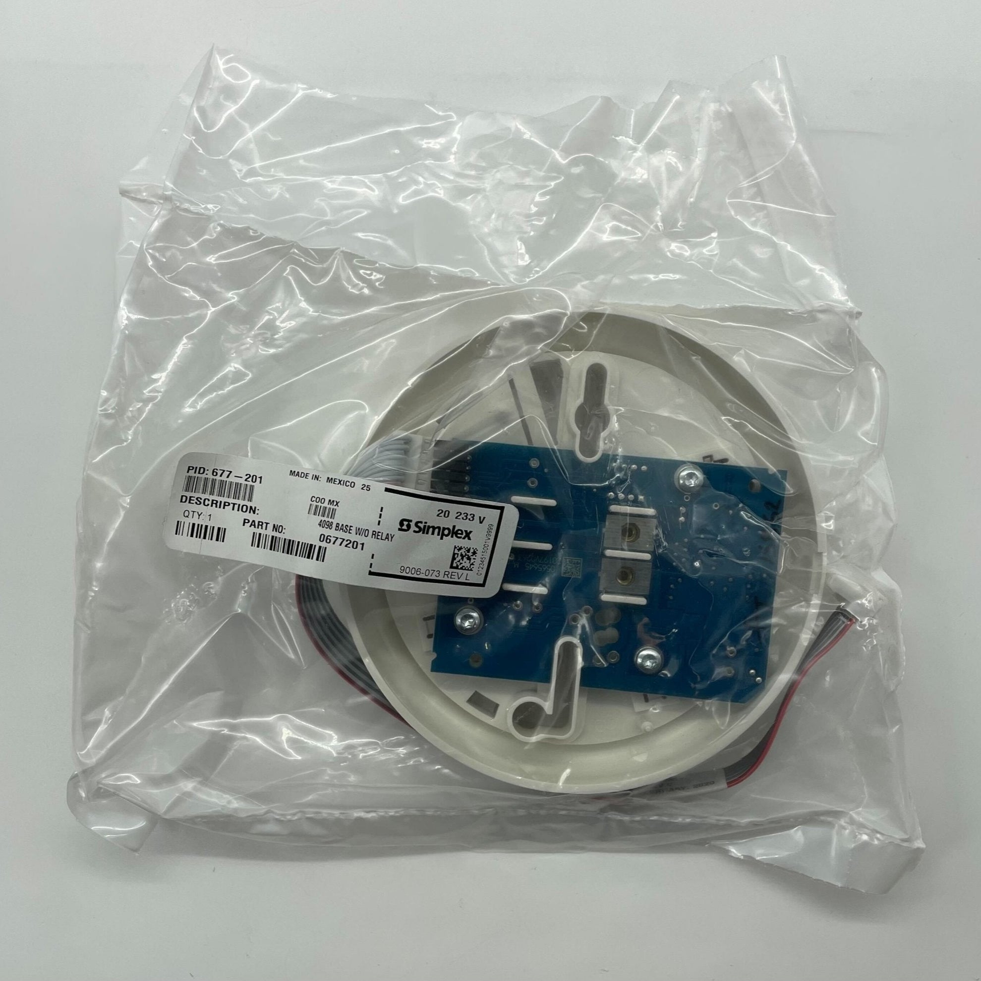 Simplex 677-201 fire alarm system sensor with warning indicator, mounted on wall in a fire safety setup.