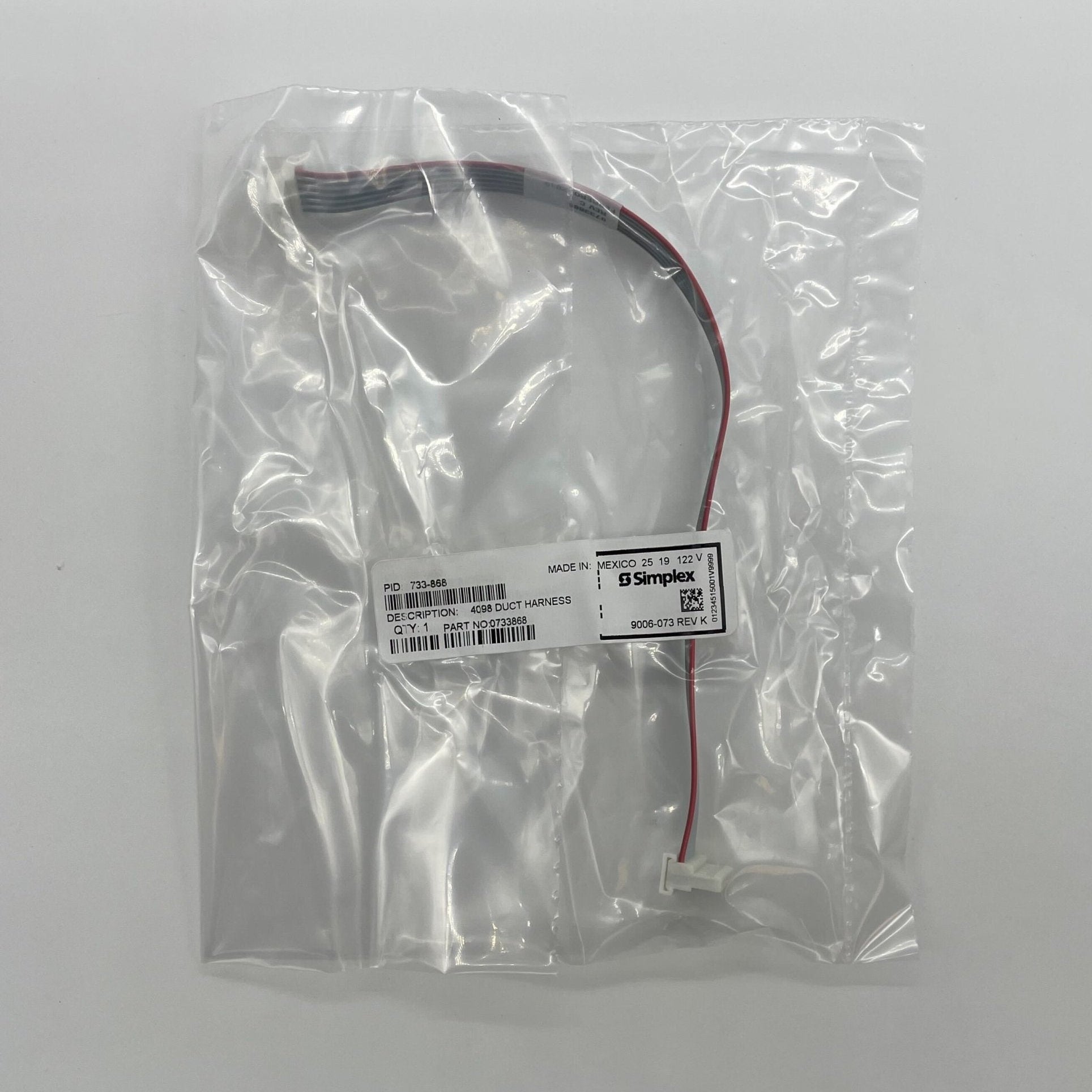 Simplex 733-868 fire alarm device, black, mounted on ceiling, part of Simplex fire alarm system for safety and detection.