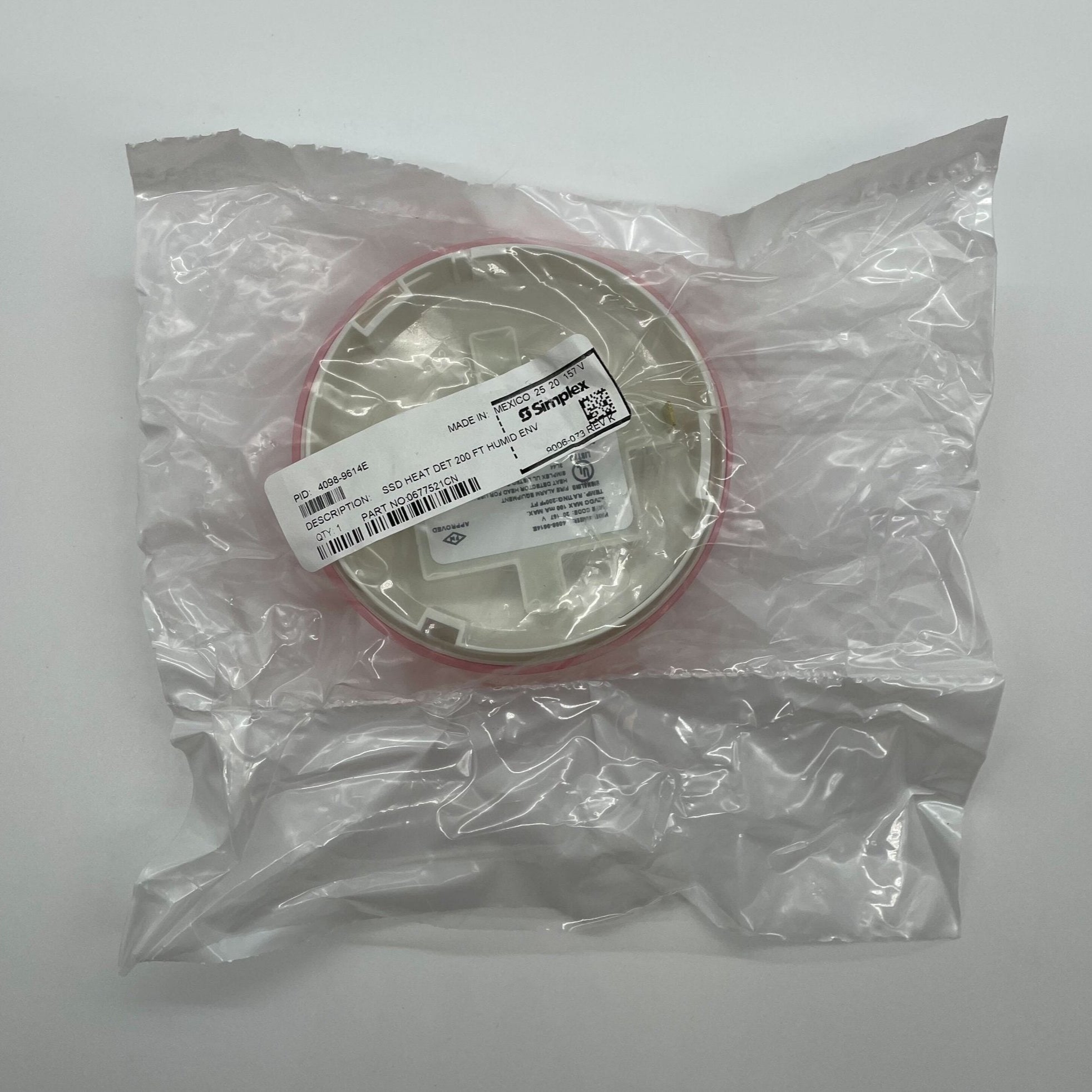 Simplex 4098-9614E heat detector, mounted on a ceiling, designed for fire safety and early heat detection in buildings.
