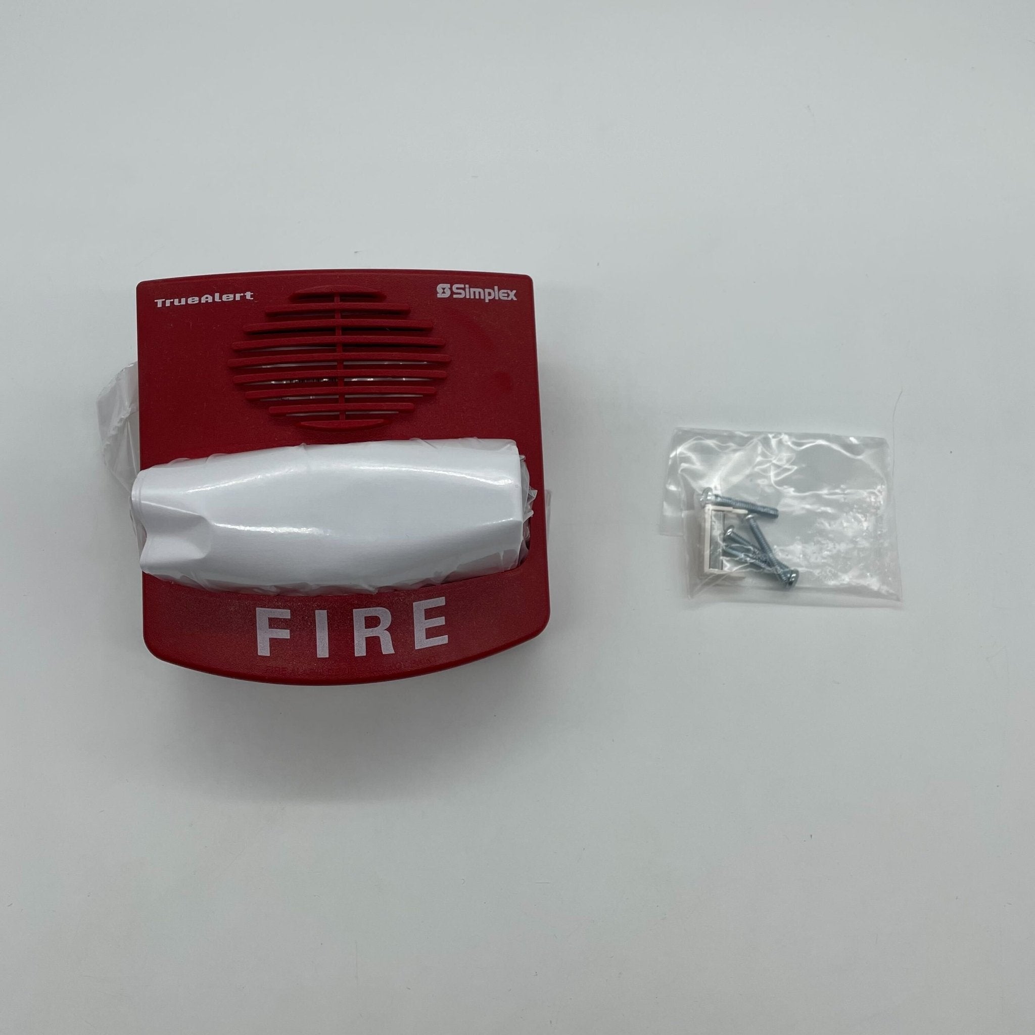 Simplex 49CMTV-WRF fire alarm with smoke and heat sensors, mounted on wall, part of Simplex fire alarm system.