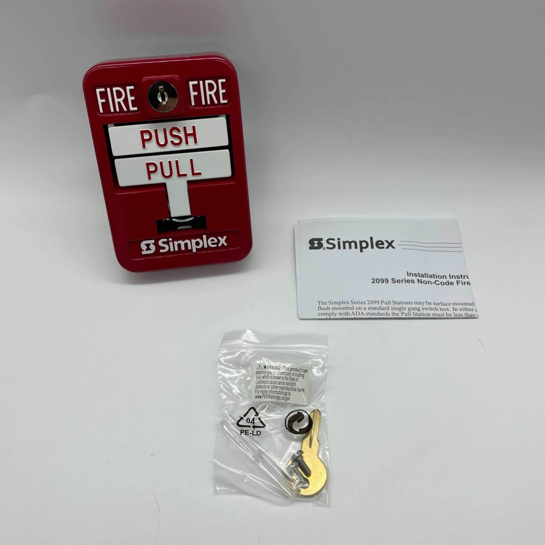 Simplex 2099-9139 pull station fire alarm switch with red casing and black handle, mounted on a wall.