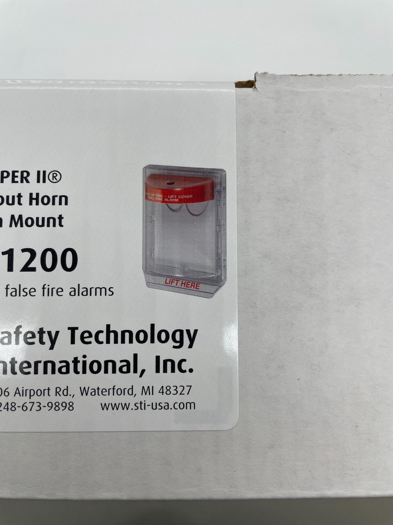 STI Stopper II flush mount fire stopper without horn, labeled for fire safety, installed on a wall with visible mounting details.