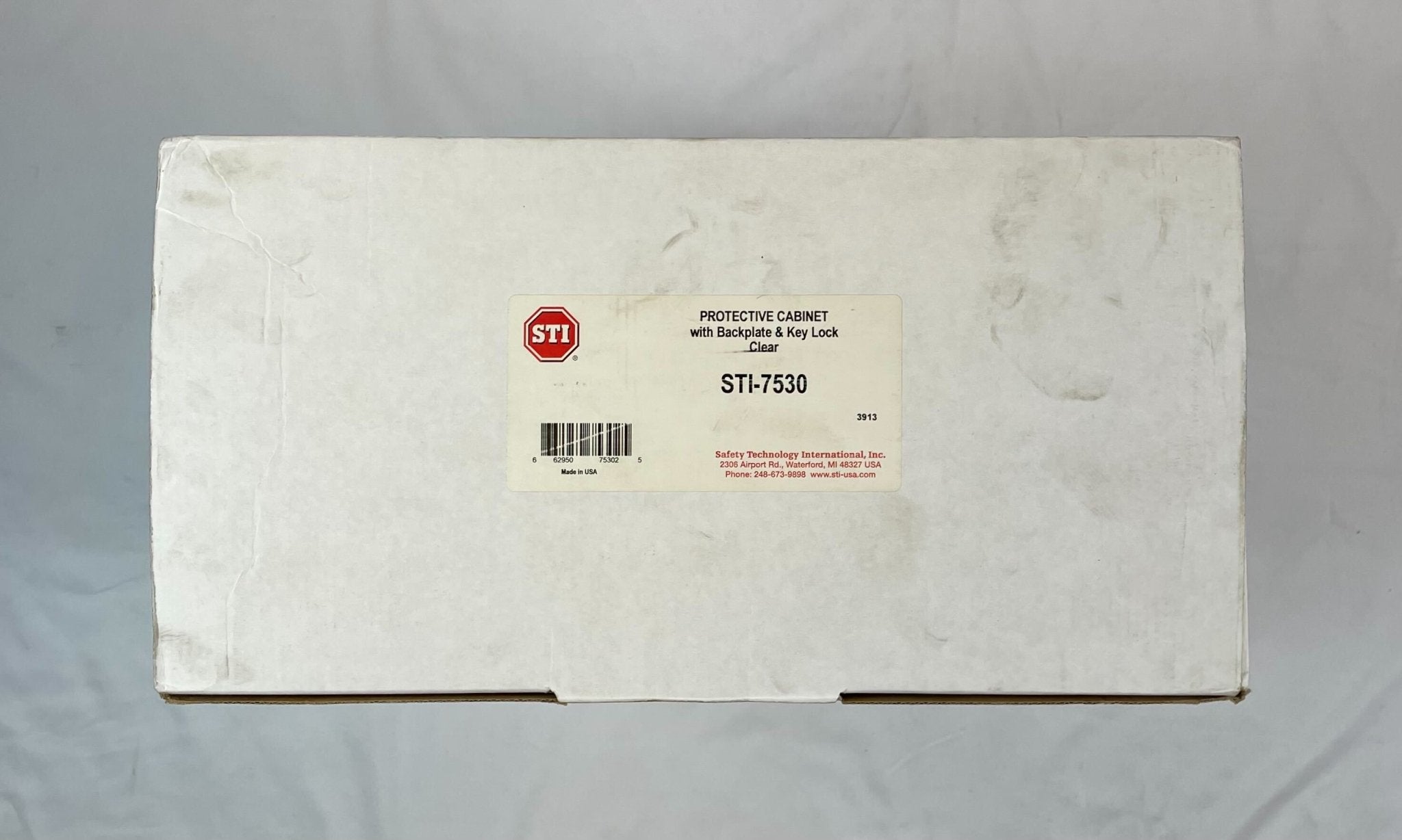 Polycarbonate STI-7530 protective cabinet with backplate, designed for stopper safety and durability, by STI.