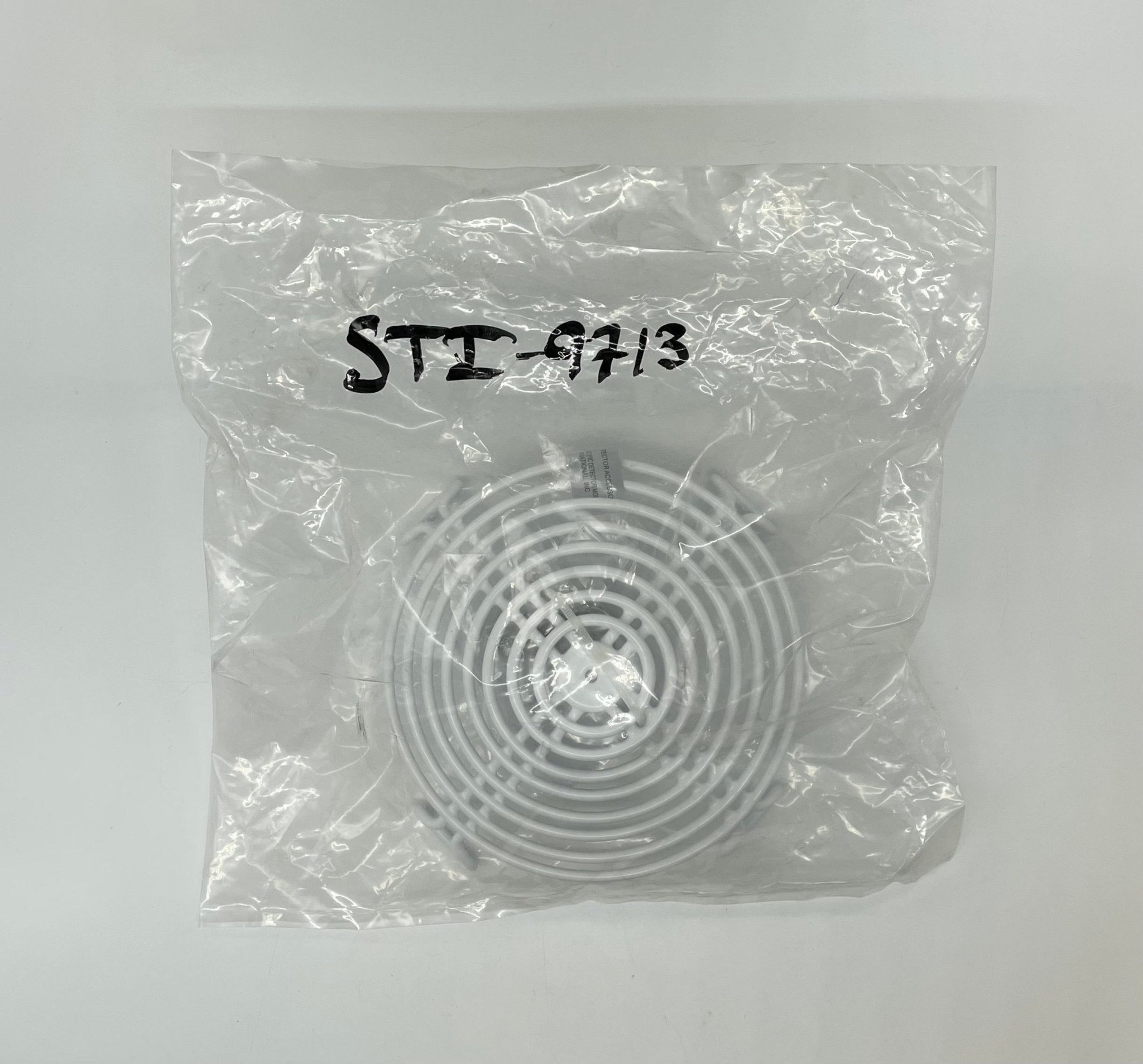 STI-9713 Steel Web Stopper cover for photoelectric smoke detector, durable metal housing for added protection.