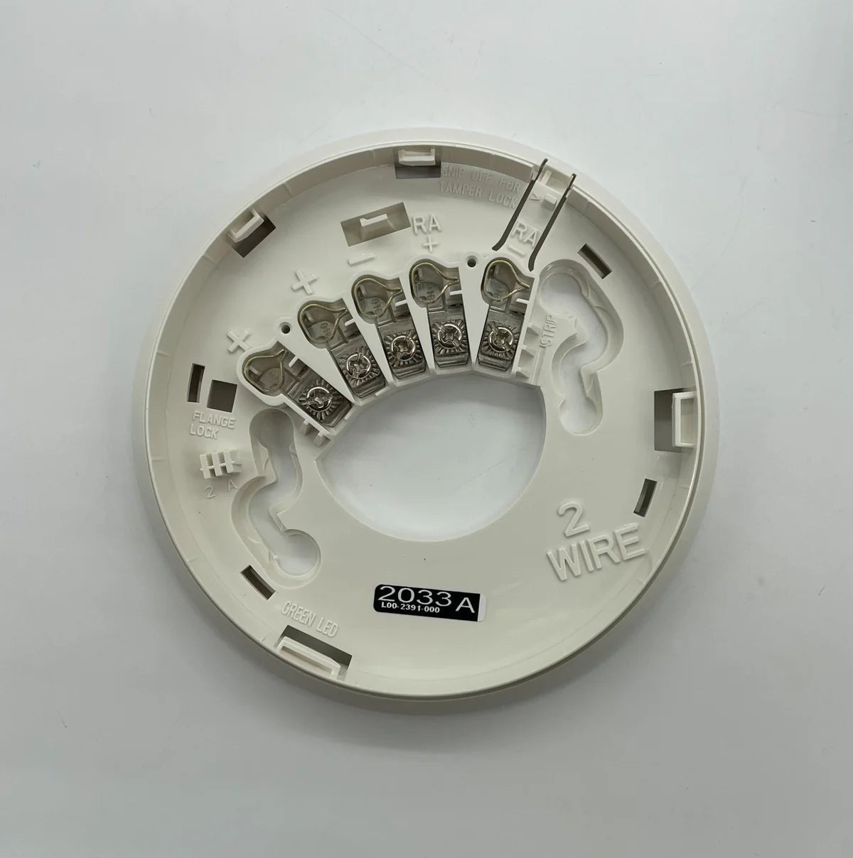 System Sensor 2WTA-B wireless temperature sensor with mounting bracket and digital display for HVAC monitoring.