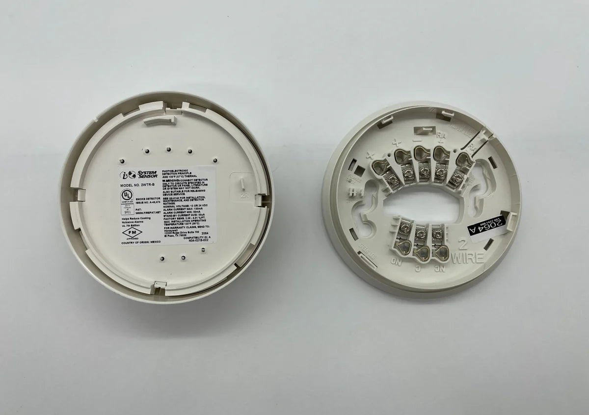 System Sensor 2WTR-B heat detector with alarm test reset button, mounted on a ceiling for fire safety detection.