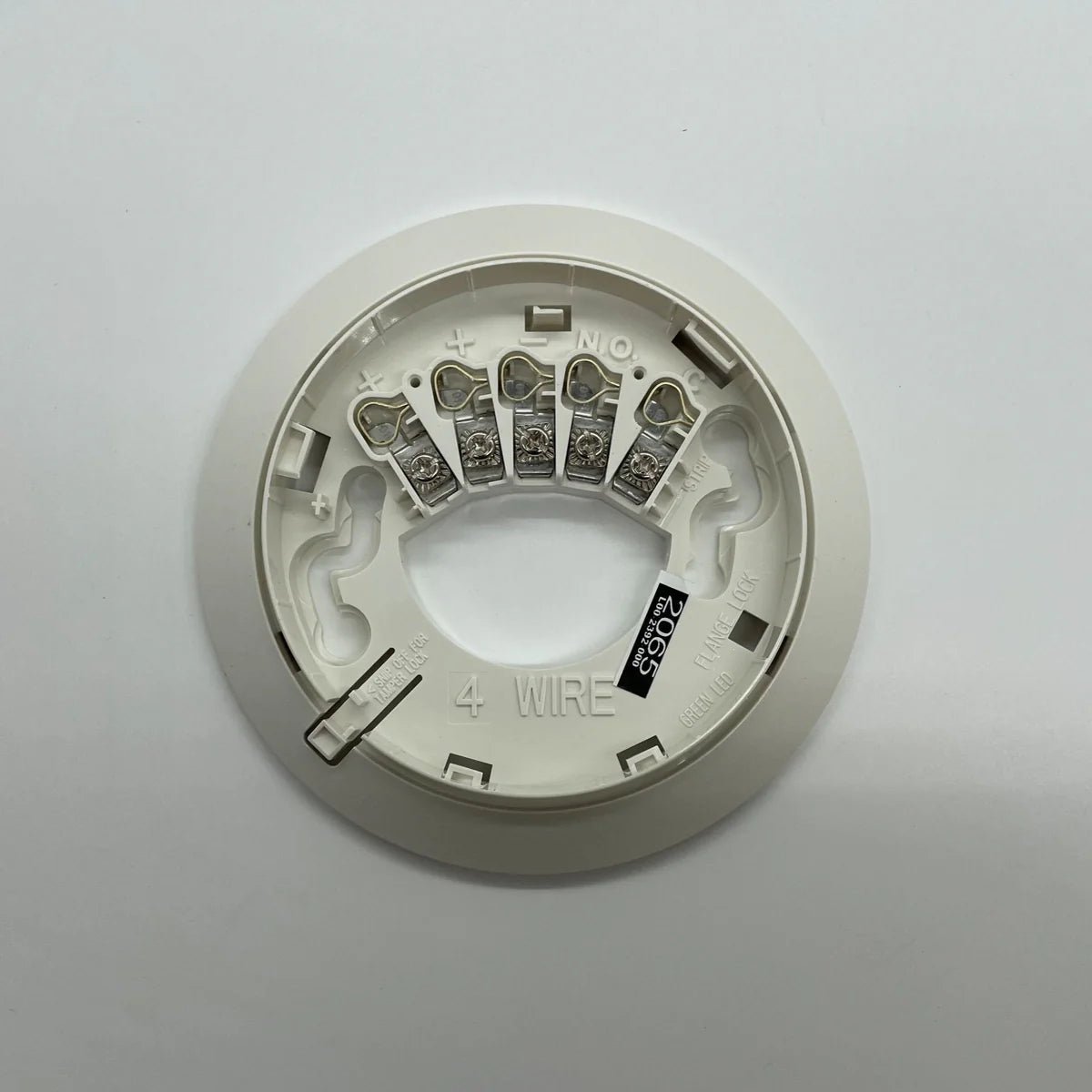 System Sensor 4W-B fire alarm control module with wiring and mounting components on a neutral background.