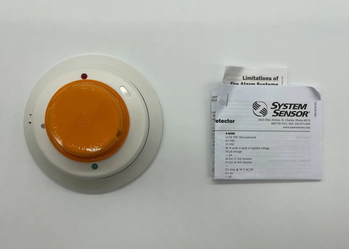 System Sensor 4W-B smoke and heat detector with alarm, mounted on ceiling in a commercial setting