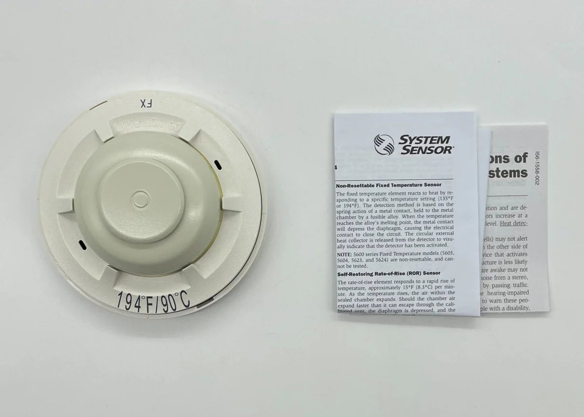 System Sensor 5604 fire alarm sensor with detection components, installed on a ceiling in a commercial setting