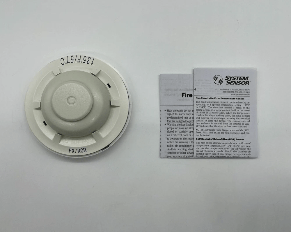 System Sensor 5621 fire alarm detector mounted on ceiling, showing its compact design and sensor components.