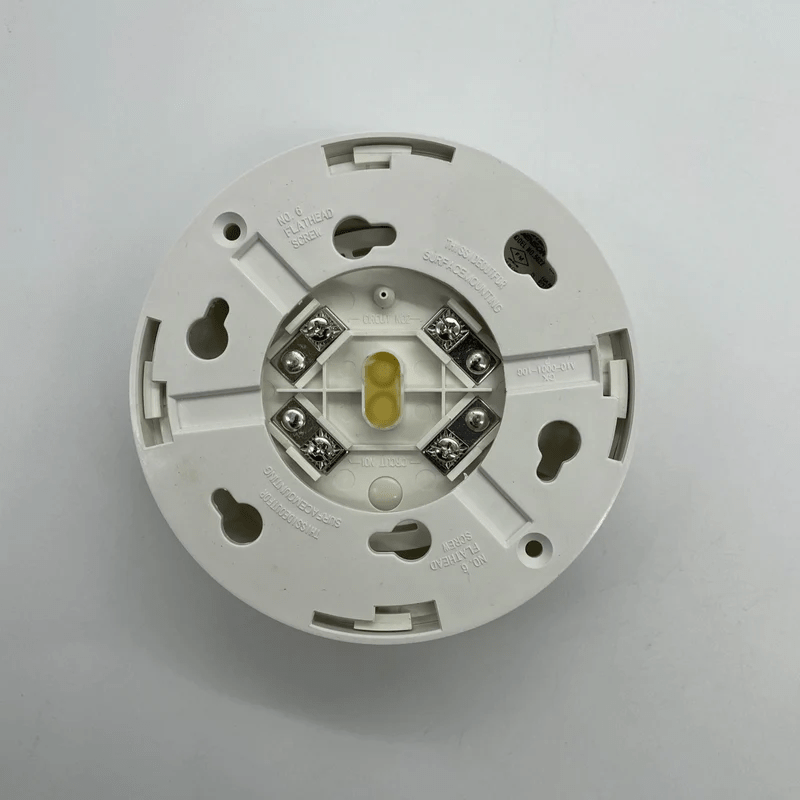 System Sensor 5622 smoke detector with alarm indicator and test button, mounted on ceiling for fire safety detection.