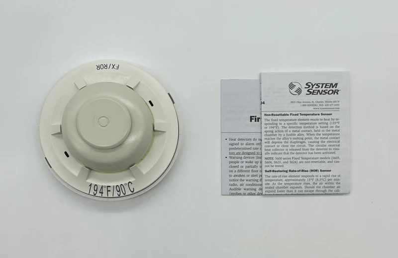 System Sensor 5622 fire alarm detector mounted on ceiling, with electronic components visible, designed for fire detection systems.