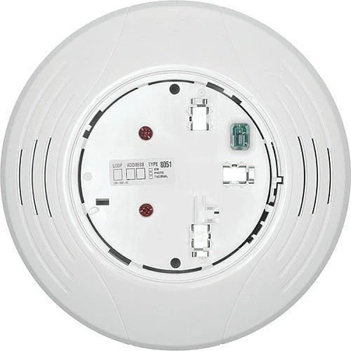 System Sensor B200S-LF-WH smoke detector mounted on ceiling in a building interior.