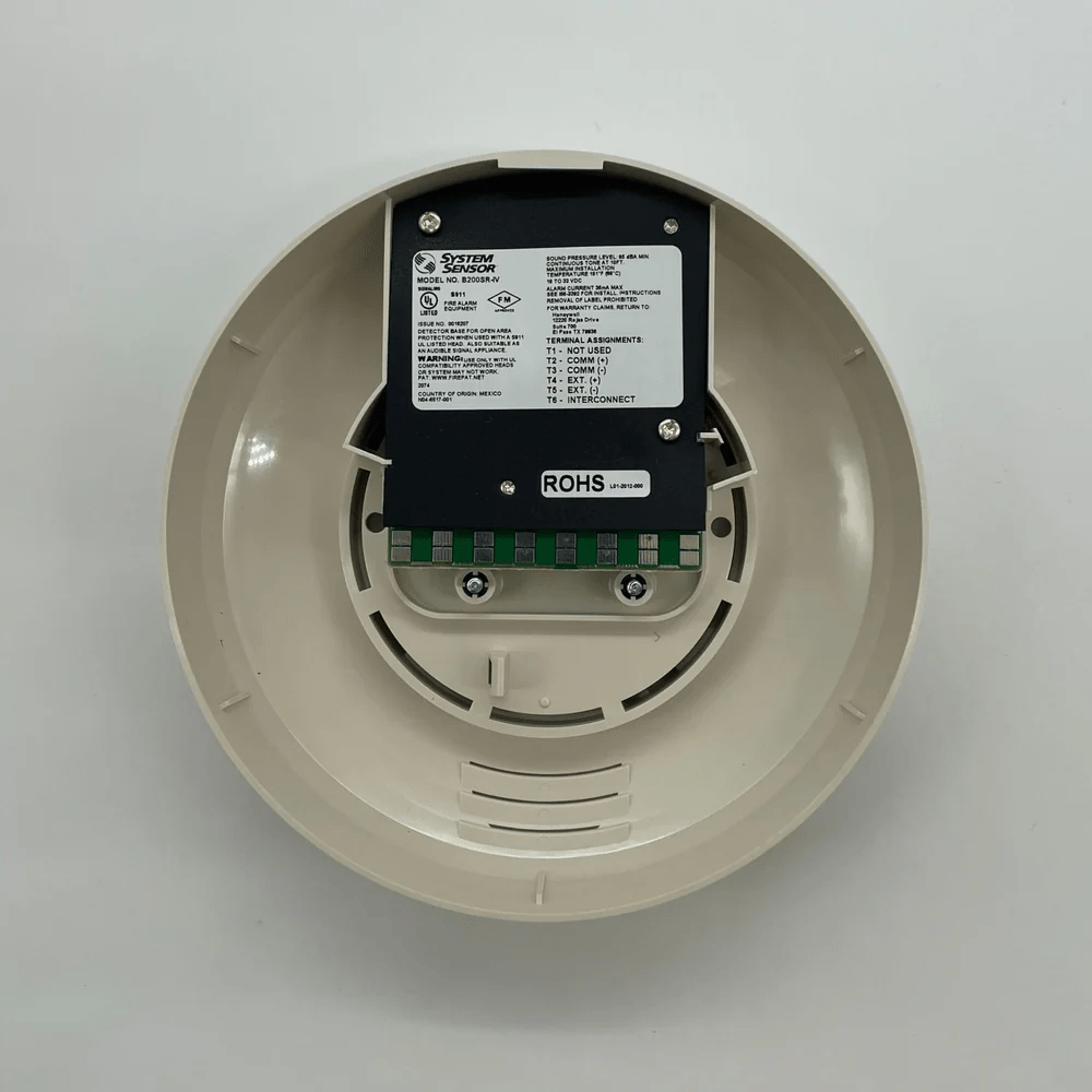 System Sensor B200SR-IV fire alarm control panel with display and control buttons, mounted on a wall.