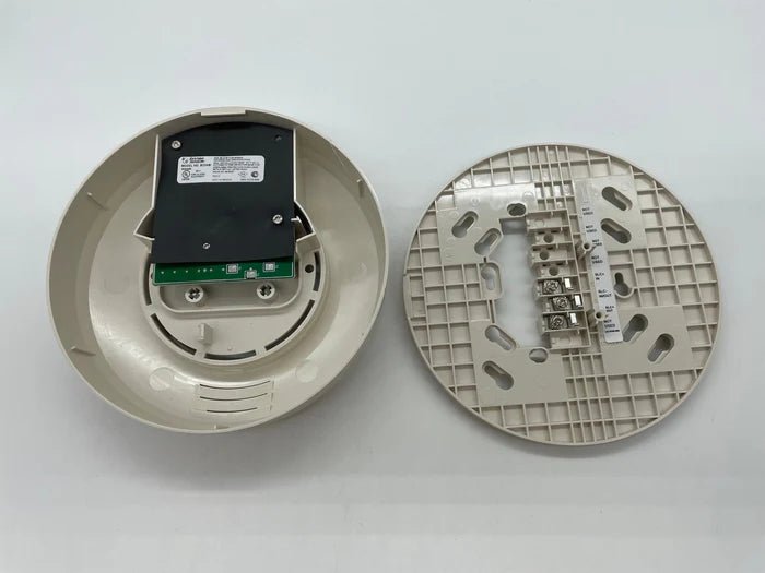 System Sensor B224BI dual-technology smoke and heat detector with mounting base, visible in the image.