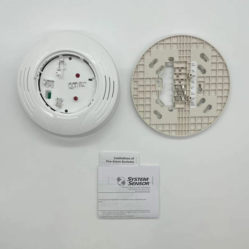 System Sensor B224BI-WH smoke detector with white plastic casing and mounting bracket, designed for residential or commercial use.