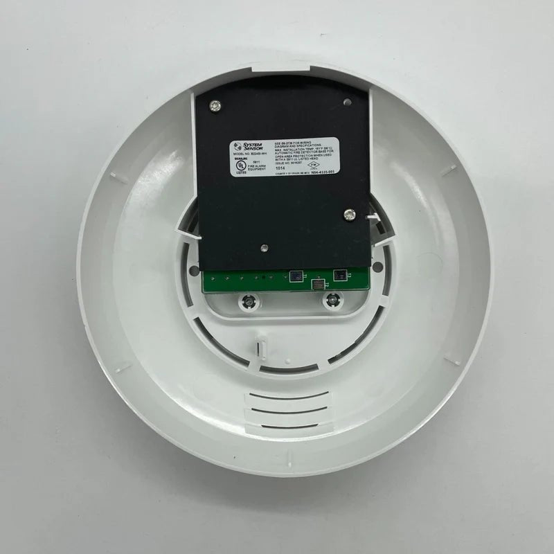 System Sensor B224BI-WH dual-technology smoke detector with white cover, mounted on ceiling for fire safety detection