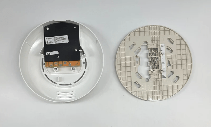 System Sensor B224RB-WH smoke detector with red LED indicator mounted on ceiling in a home setting