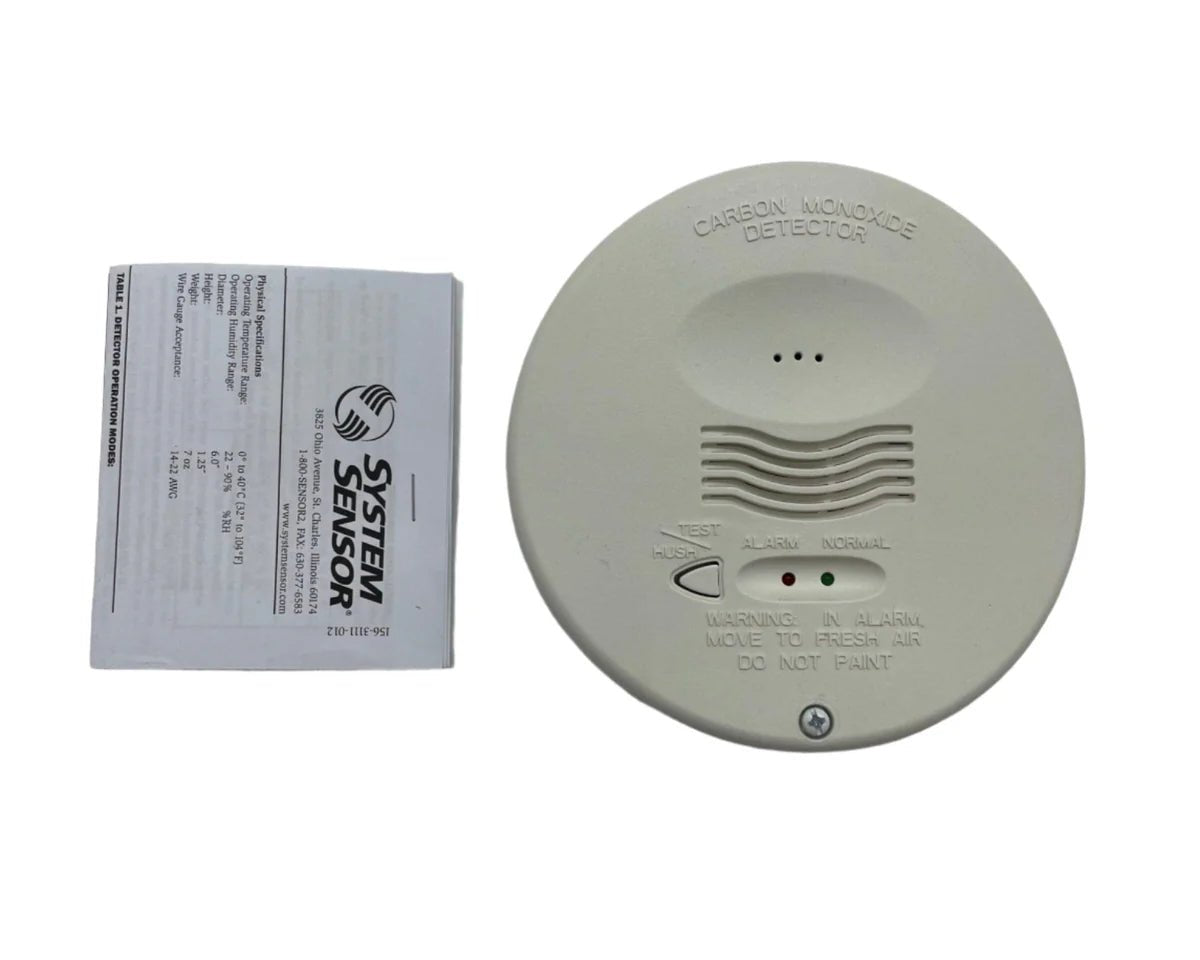System Sensor CO1224TR carbon monoxide detector with digital display and alarm, mounted on a wall.