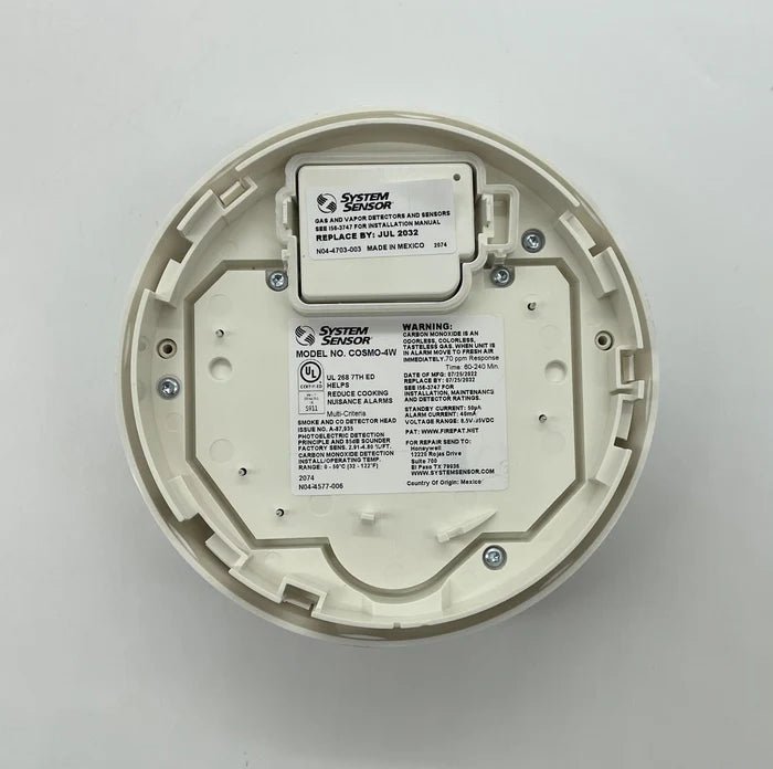 System Sensor COSMO-4W wireless smoke and heat detector with sleek design and mounting bracket for fire safety systems.