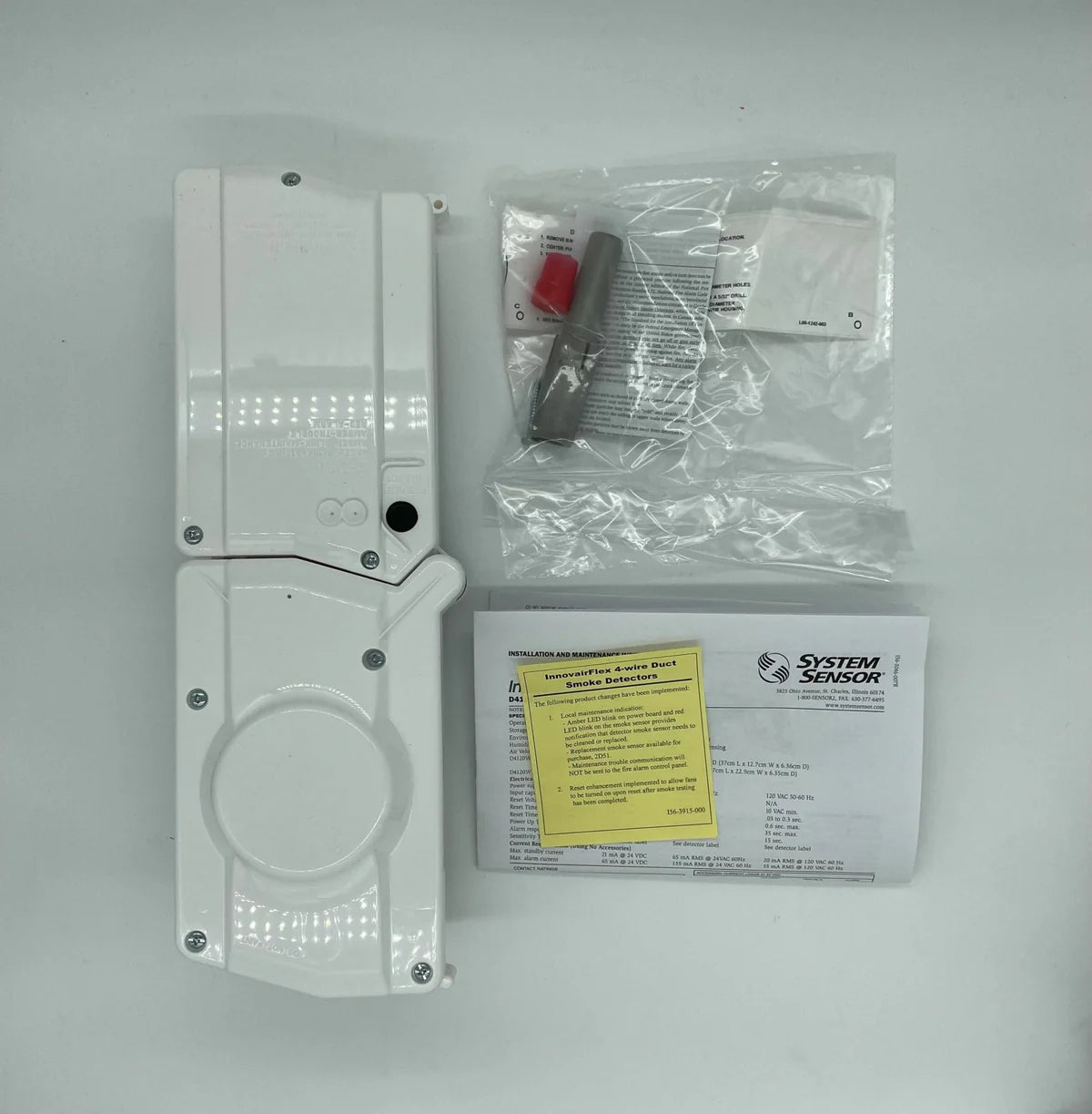 System Sensor D4120W fire alarm detector with white cover and mounting bracket, designed for residential or commercial fire safety.