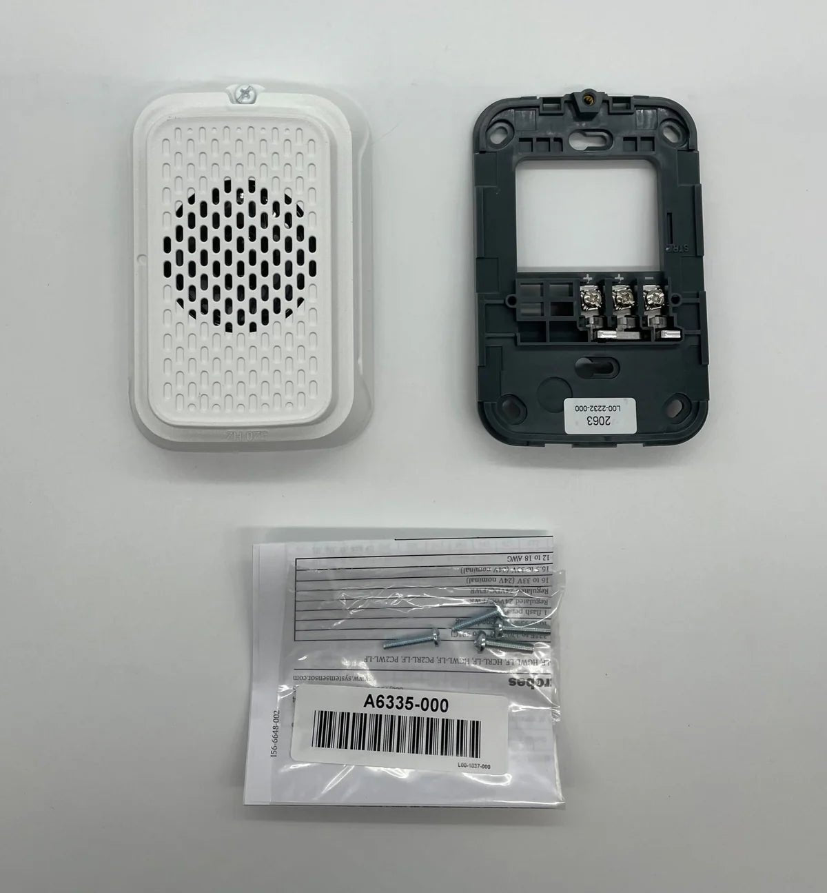 System Sensor HGWL-LF fire alarm detector with black housing and wiring terminals, mounted on a white ceiling.