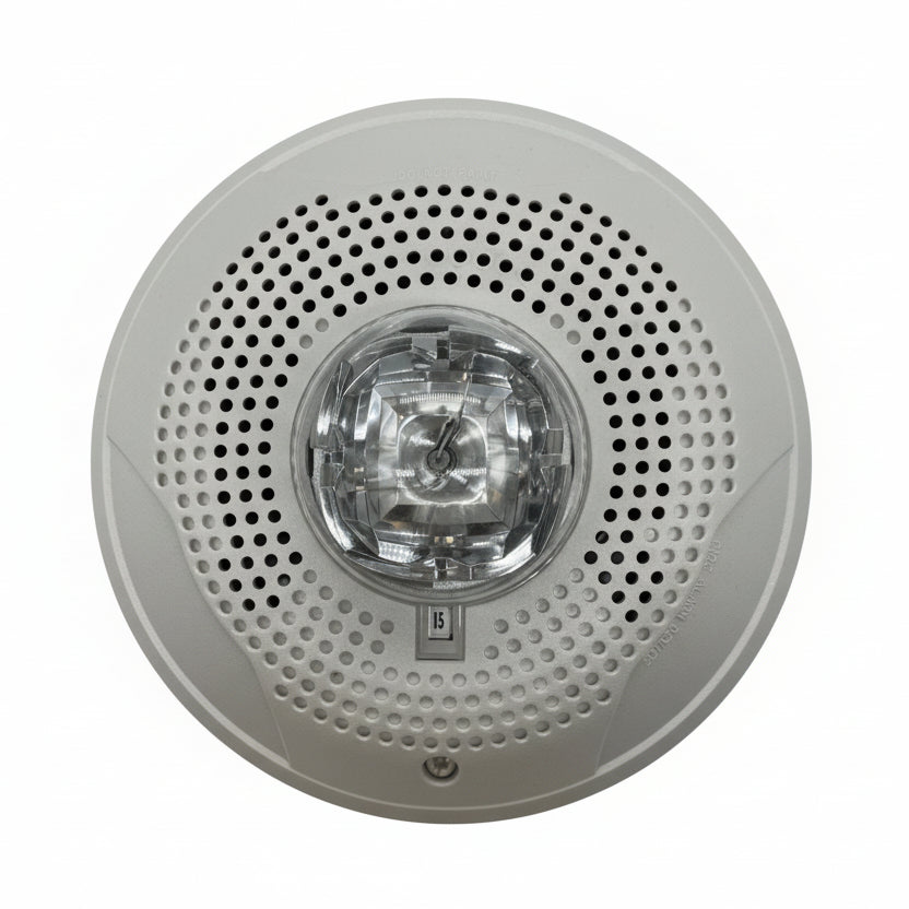 System Sensor PC4W fire alarm control panel with display and control buttons, mounted on a wall.