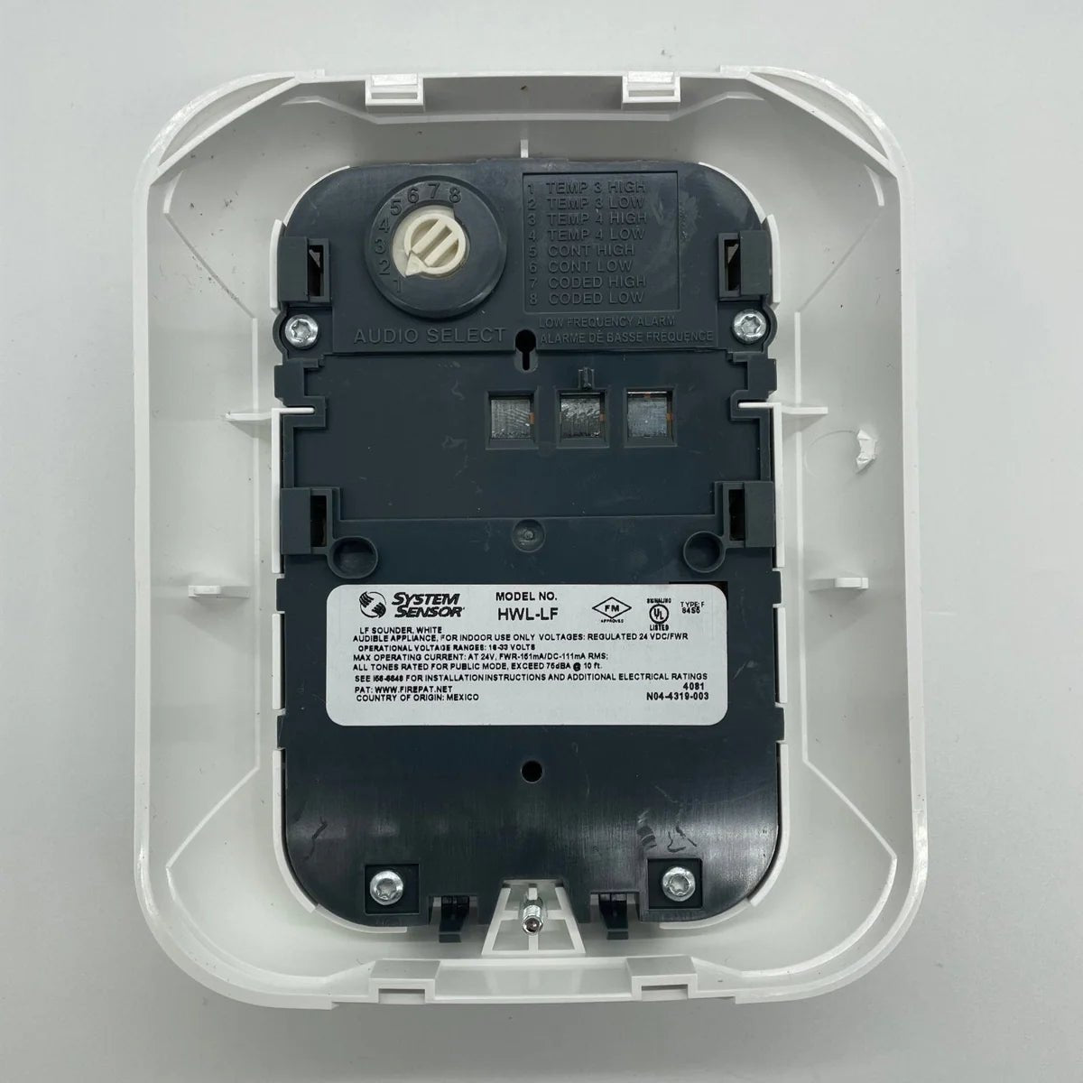 System Sensor HWL-LF smoke detector with low-profile design, mounted on ceiling in a commercial setting.