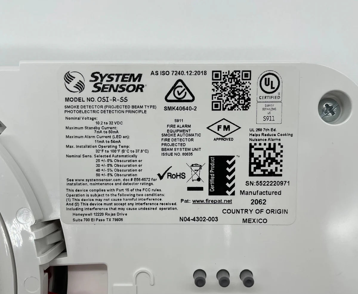 System Sensor OSI-R-SS smoke detector with white casing and mounting hardware, designed for fire safety systems.