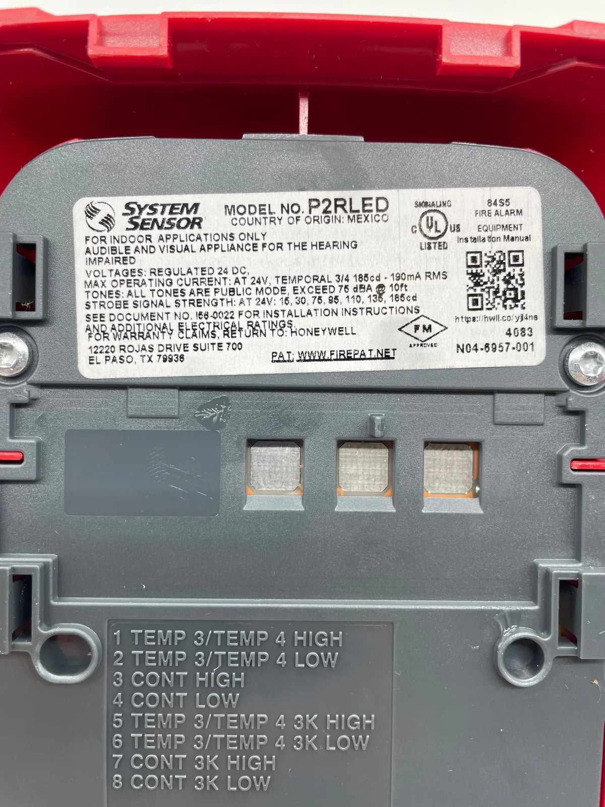 System Sensor P2RLED emergency LED indicator light mounted on a panel for fire alarm systems.